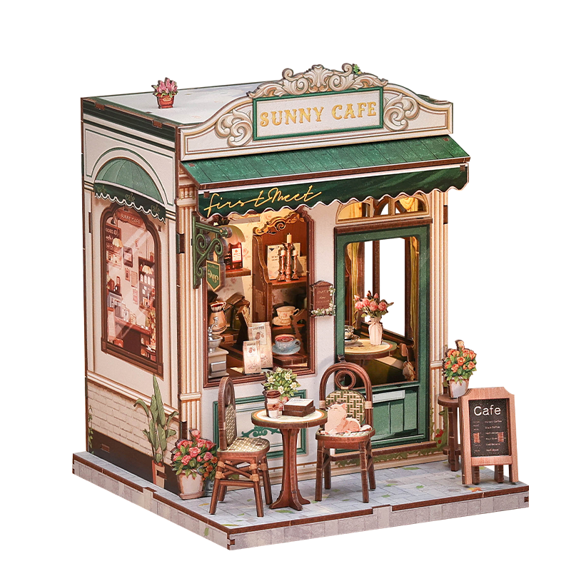 Model of a miniature cafe with 'Bunny Cafe' sign, detailed interior, and decorative elements.